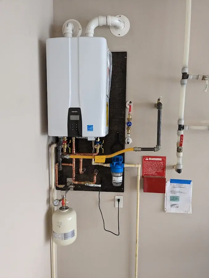 Professional plumber installing copper piping in a Brownfields home